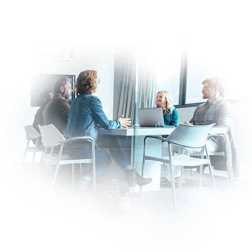 Men and women sitting around conference table