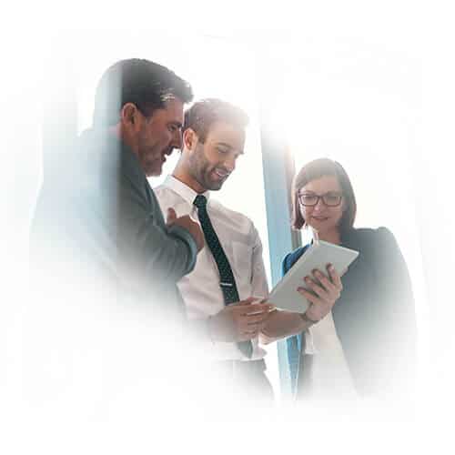 Three professionals looking at tablet